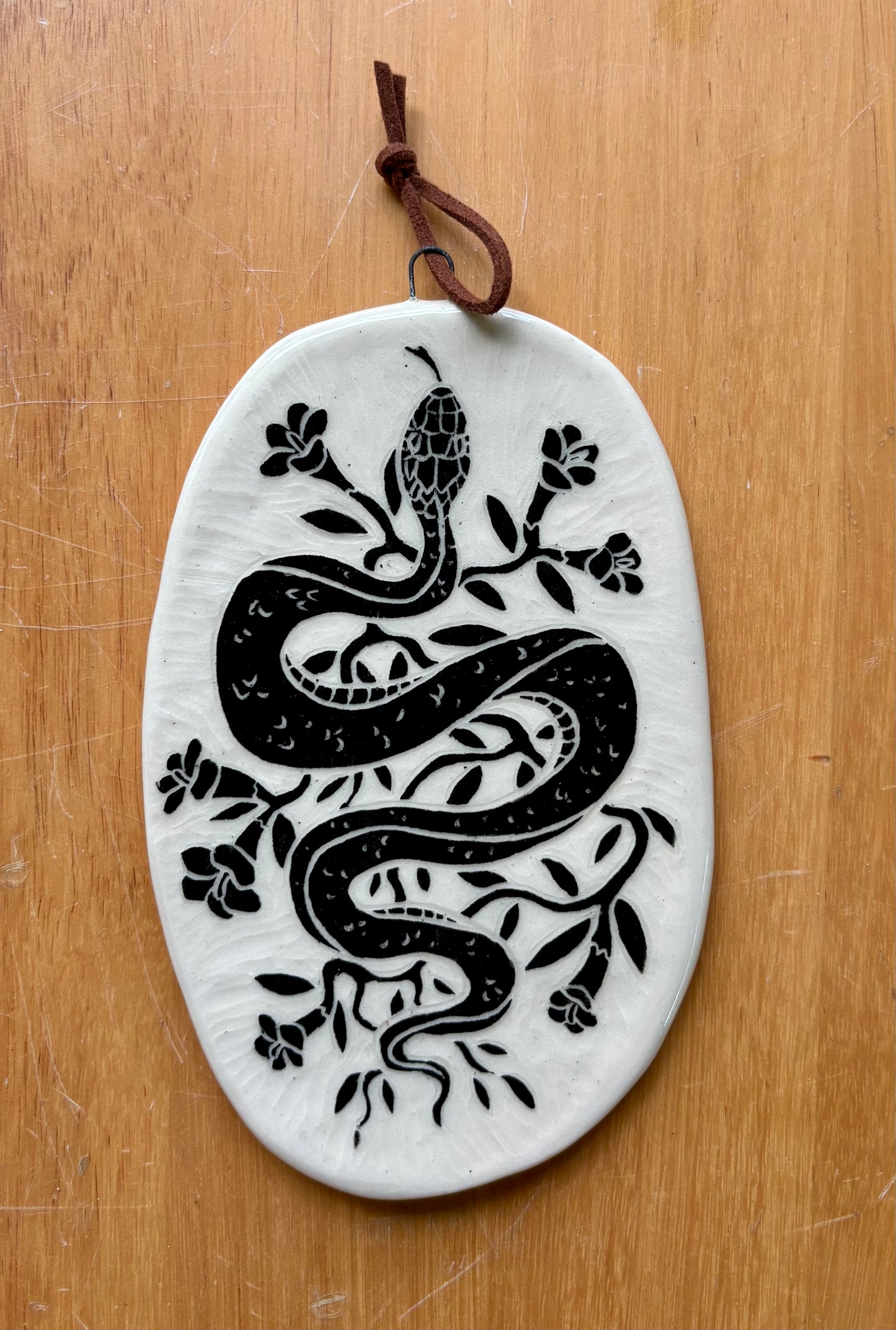 Snake and flowers wall hanging