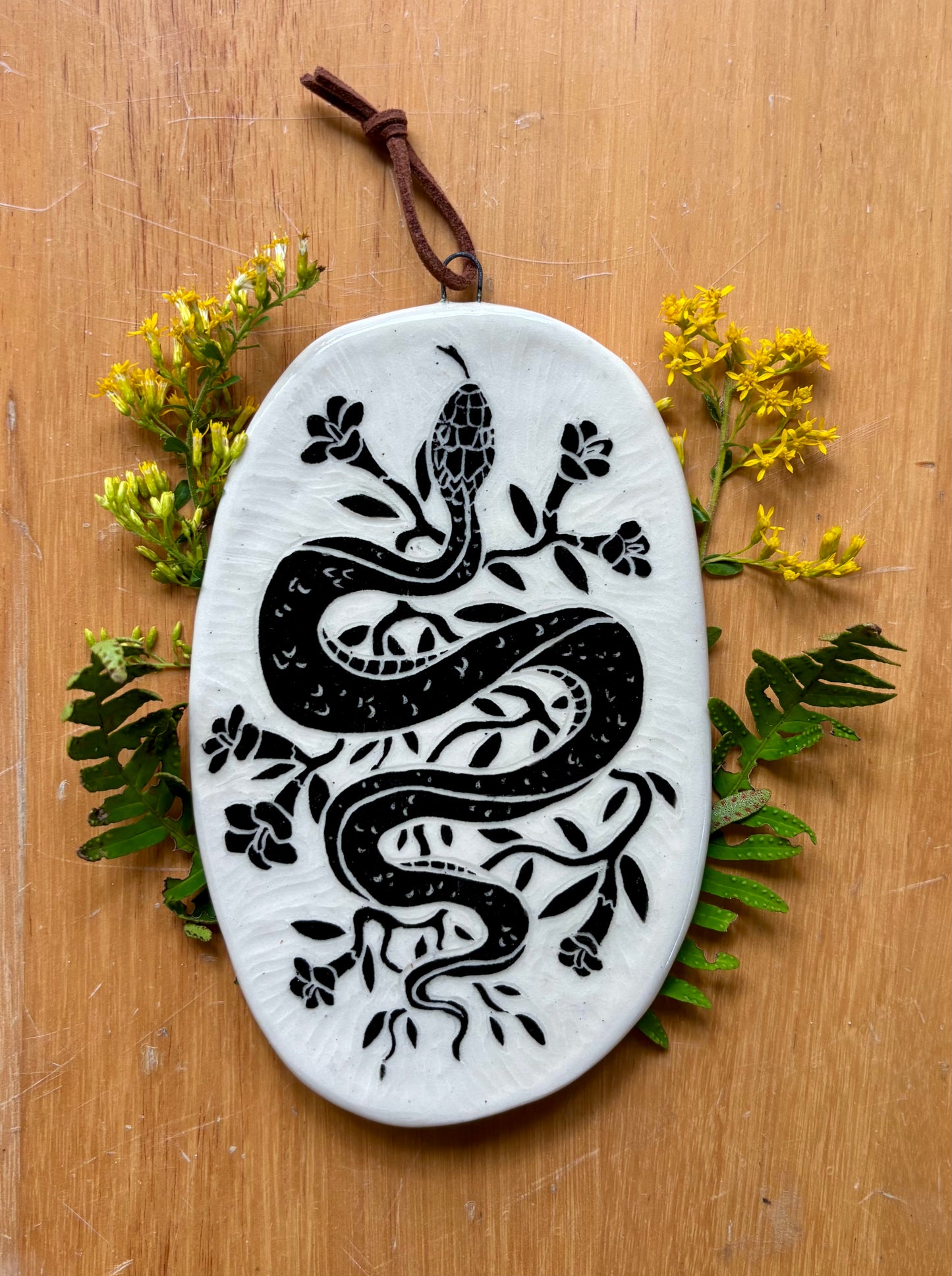 Snake and flowers wall hanging